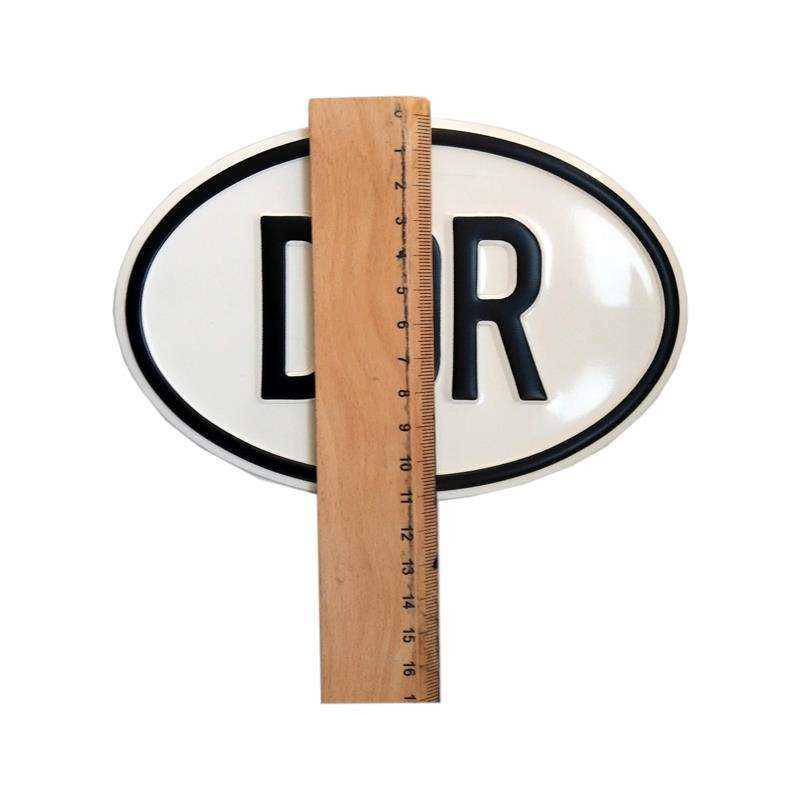 owalna tabliczka, elipsa, białe tło, czarny napis PL